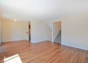 Thumbnail 2 of 29 - a living room with a hard wood floor and a staircase