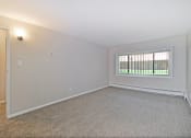 Thumbnail 10 of 29 - the spacious living room of an empty home with a window