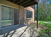 Thumbnail 23 of 29 - the front porch of a brick house with sliding glass doors
