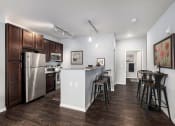 Thumbnail 1 of 23 - a kitchen with stainless steel appliances and a bar with stools
