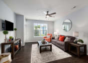 Thumbnail 3 of 23 - a living room with a couch and a ceiling fan