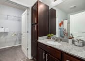 Thumbnail 5 of 23 - a bathroom with a sink and a shower and a mirror