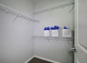 Thumbnail 7 of 23 - a closet with shelves and baskets on the wall