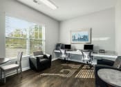 Thumbnail 15 of 23 - an office with a large window and a desk with chairs