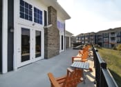 Thumbnail 10 of 23 - a patio with benches and tables in front of a building