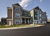 Thumbnail 19 of 23 - an apartment building with a street in front of it