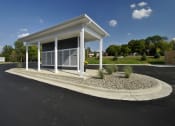 Thumbnail 20 of 23 - a small office building with white pillars and a gravel driveway