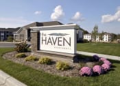 Thumbnail 21 of 23 - apartments sign in front of grass and flowers