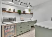 Thumbnail 5 of 46 - a kitchen with green cabinets and a counter top and a microwave