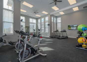 Thumbnail 5 of 27 - an indoor gym with exercise bikes and windows