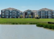 Thumbnail 15 of 27 - an image of an apartment building overlooking a lake