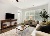 Thumbnail 17 of 27 - a living room with a couch and a tv