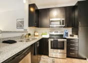Thumbnail 23 of 27 - a kitchen with stainless steel appliances and granite counter tops