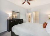 Thumbnail 25 of 27 - a bedroom with a large bed and a ceiling fan