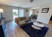 Thumbnail 16 of 46 - a living room with a couch and a table