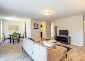 Thumbnail 14 of 46 - a living room with a couch and a tv