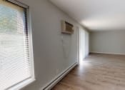 Thumbnail 44 of 46 - a empty room with a wall air conditioner and a window