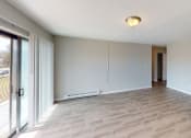 Thumbnail 39 of 46 - a living room with a wood floor and a sliding glass door