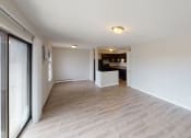 Thumbnail 41 of 46 - a renovated living room and kitchen with wood flooring and white walls