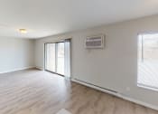 Thumbnail 38 of 46 - an empty living room with a sliding glass door to a patio