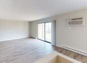 Thumbnail 37 of 46 - an empty living room with a sliding glass door to a patio