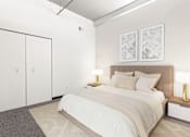 Thumbnail 22 of 29 - a bedroom with a bed and two white closets