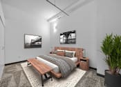 Thumbnail 6 of 29 - A bedroom with a bed, nightstand, and a potted plant.