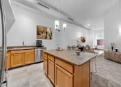 Thumbnail 1 of 29 - A kitchen with wooden cabinets and a marble countertop.