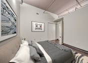 Thumbnail 7 of 29 - A bedroom with a bed and a picture on the wall.