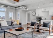 Thumbnail 1 of 10 - a living room with couches and chairs and a table