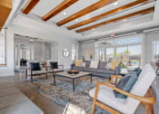 Thumbnail 2 of 10 - a living room with a couch and chairs and a large window