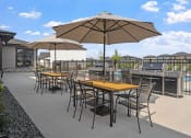 Thumbnail 8 of 10 - a patio with tables and chairs and umbrellas