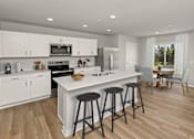 Thumbnail 1 of 8 - A modern kitchen with white cabinets and a large island.