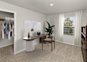 Thumbnail 6 of 8 - A room with a desk, chair, and a plant.
