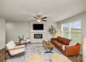 Thumbnail 6 of 32 - A living room with a fireplace and a television.