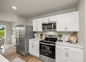 Thumbnail 2 of 32 - A modern kitchen with white cabinets and stainless steel appliances.