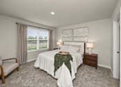 Thumbnail 13 of 32 - A bedroom with a bed, nightstand, chair, and window.