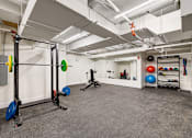 Thumbnail 17 of 26 - a workout room with weights and other exercise equipment in a large space