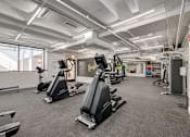 Thumbnail 16 of 26 - a gym with treadmills and other exercise equipment in a building