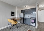 Thumbnail 13 of 26 - a kitchen with a table and chairs and a refrigerator
