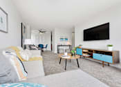 Thumbnail 11 of 26 - a living room with a couch and a tv