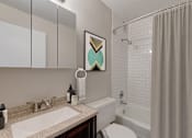 Thumbnail 6 of 26 - a bathroom with a shower and a sink and a toilet