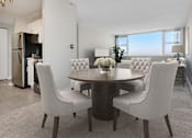 Thumbnail 2 of 26 - a dining room with a table and chairs