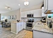 Thumbnail 1 of 43 - a kitchen with granite counter tops and stainless steel appliances