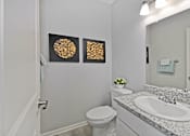 Thumbnail 13 of 43 - a bathroom with a sink and a toilet and a mirror