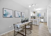 Thumbnail 9 of 43 - a dining room with a table and chairs