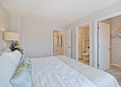 Thumbnail 8 of 43 - a bedroom with a large bed and a closet     and a bathroom