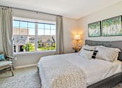 Thumbnail 6 of 43 - a bedroom with a large window and a bed