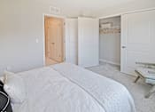 Thumbnail 7 of 43 - a bedroom with a bed and closet and a closet door open