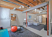 Thumbnail 17 of 43 - a living room with a large unfinished basement with exposed beams